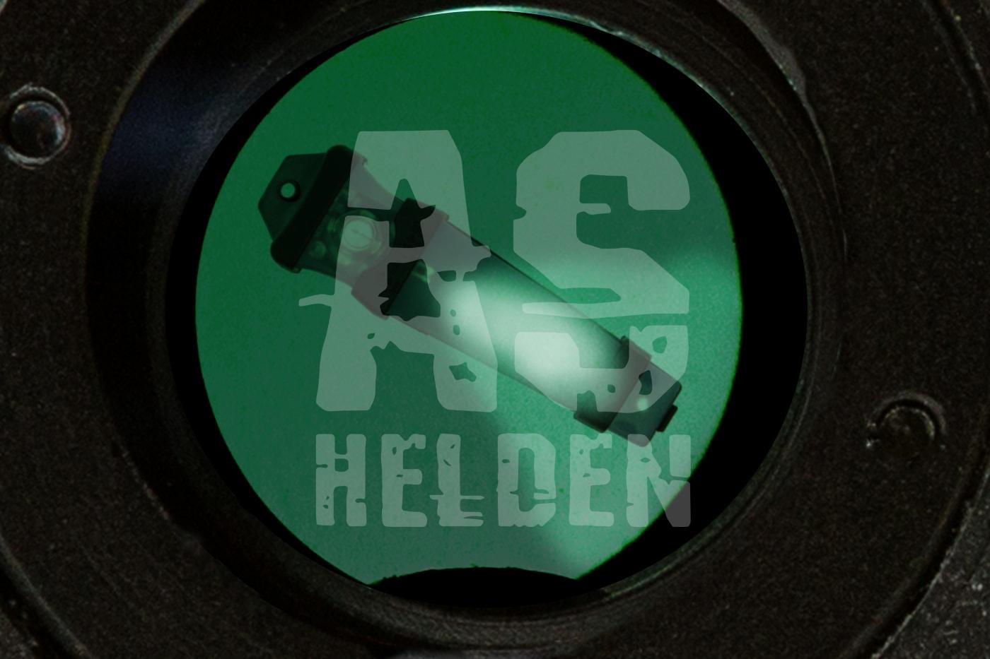 Grüner Sichtfilter mit Airsoft-Helden-Logo und Montagehalterung im Fokus.