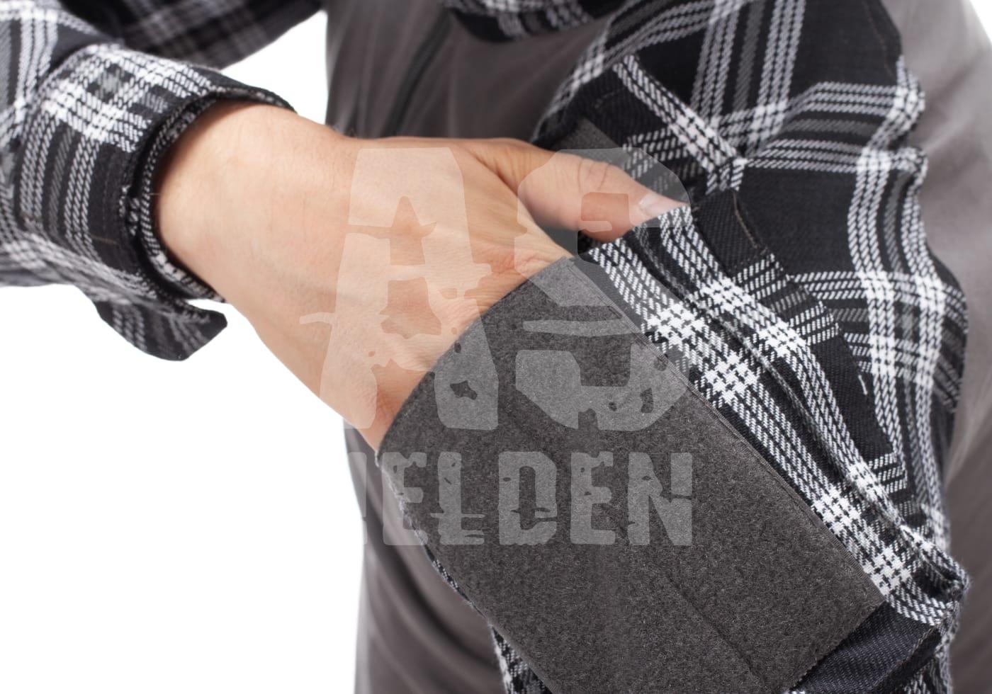 Arm in schwarzem Karo-Hemd mit grauem Ellenbogenschoner, Nahaufnahme.
