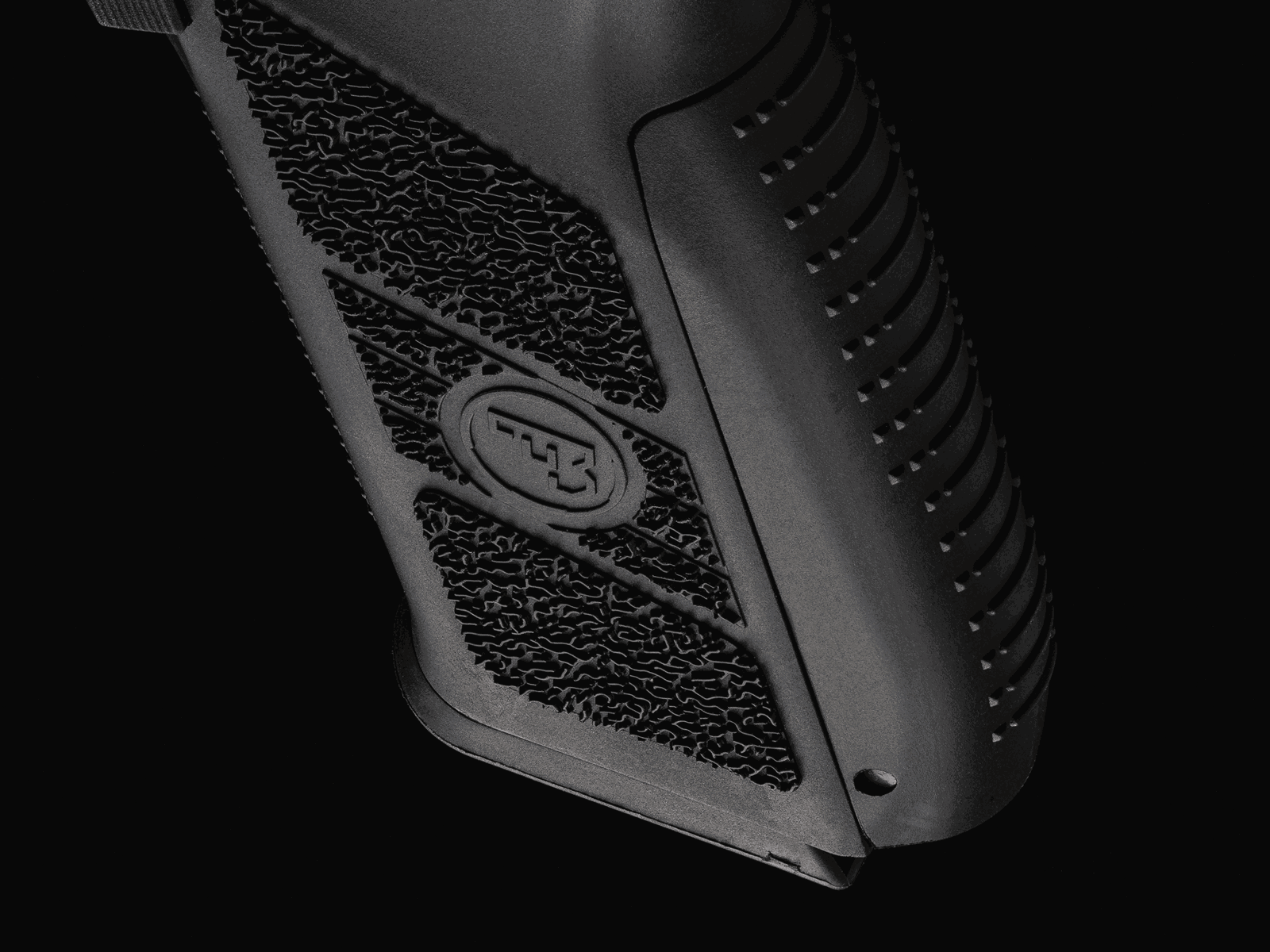 Griffstück einer Airsoft-Pistole mit Textur und Logo, Nahaufnahme auf dunklem Hintergrund.